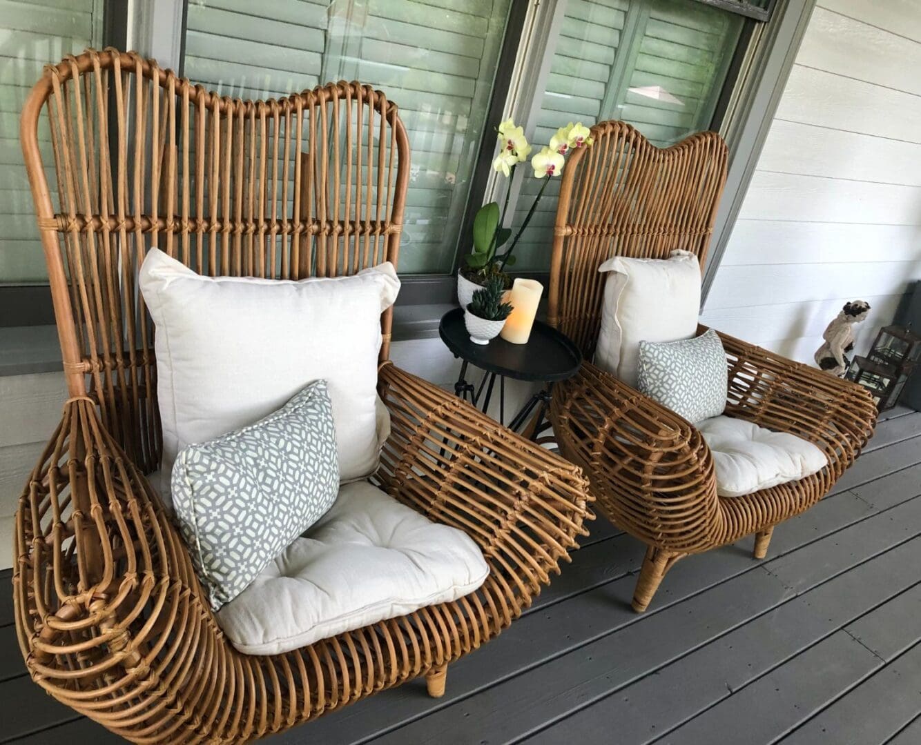 A couple of chairs on top of a porch.