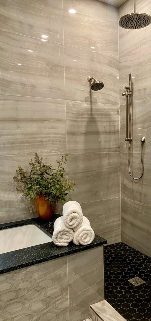 A bathroom with a shower and tiled walls.