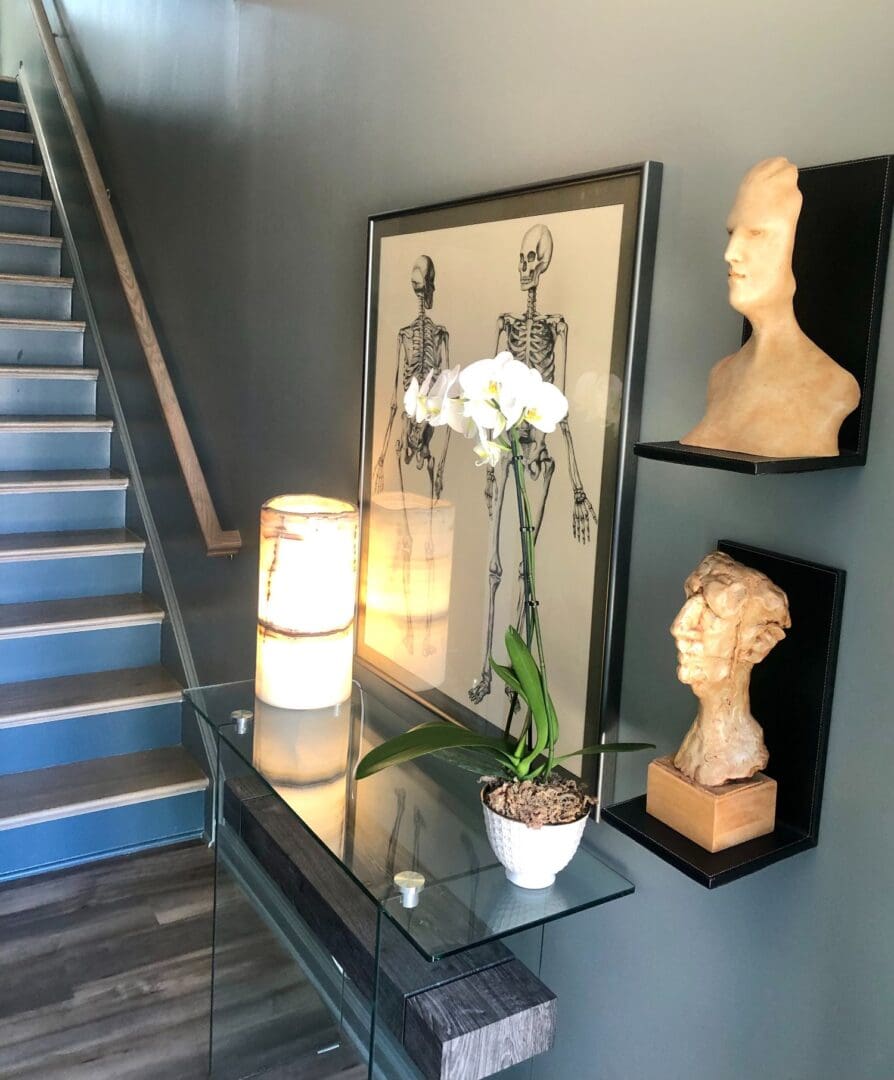 A staircase with two shelves and a glass table.